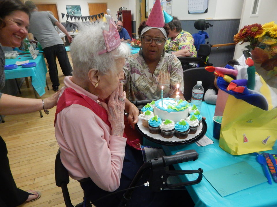 Ms. Virginia with birthday cake and cupcakes