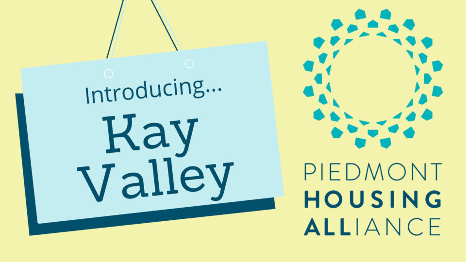 on the left there is a sign that says Introducing... Kay Valley, blue piedmont housing alliance logo on the right, yellow background